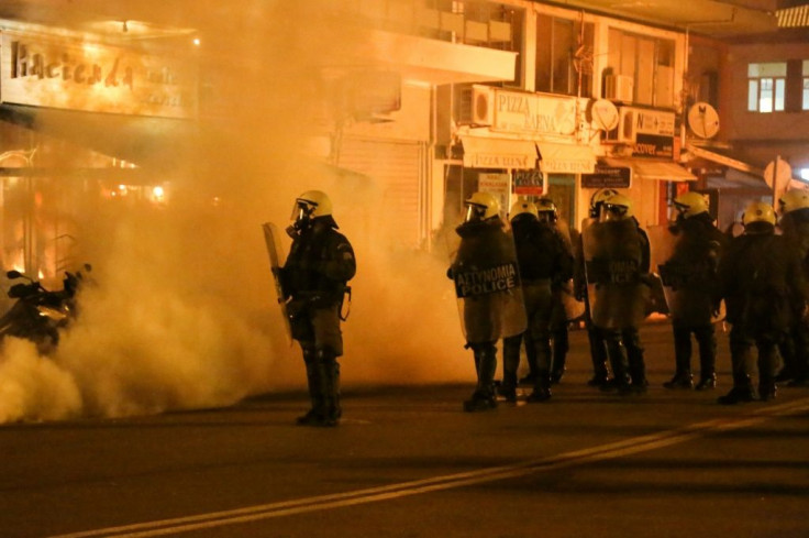 Riot police use tear gas during clashes with demonstrators protesting against the construction of controversial new migrant camps on Lesbos island