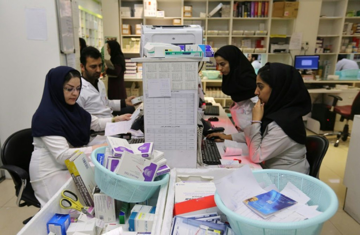 Iranian medical staff at the state-run "13 Aban" pharmacy in Tehran -- hordes of patients queue patiently for hours as the dispensary stocks and subsidises medicines for rare diseases