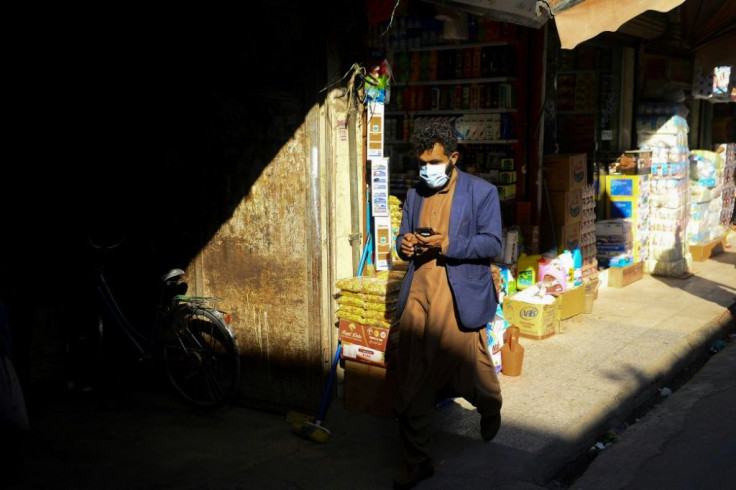 A man wearing a protective facemask walks in a market in Herat city, Afghanistan, after the country detected its first novel coronavirus case