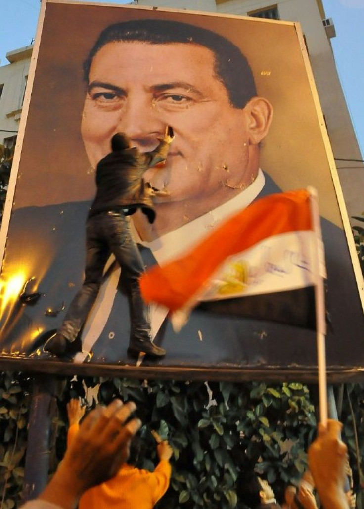 Demonstrators tear a portrait of Hosni Mubarak during a protest against his rule in the northern port city of Alexandria on January 25, 2011