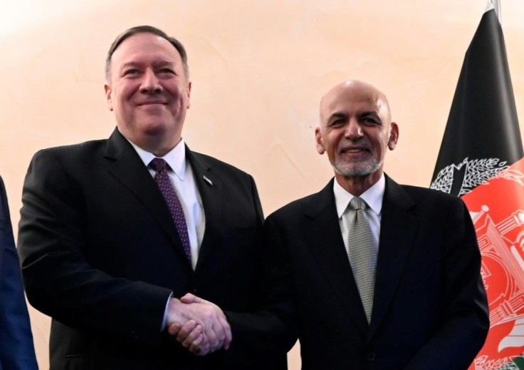 Afghan President Ashraf Ghani, pictured (right) with Pompeo in February 2020, was declared the winner in disputed elections