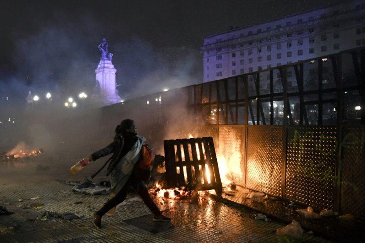 A woman throws a bottle at riot police outside the National Congress in Buenos Aires in 2018 after senators rejected the bill to legalize abortion