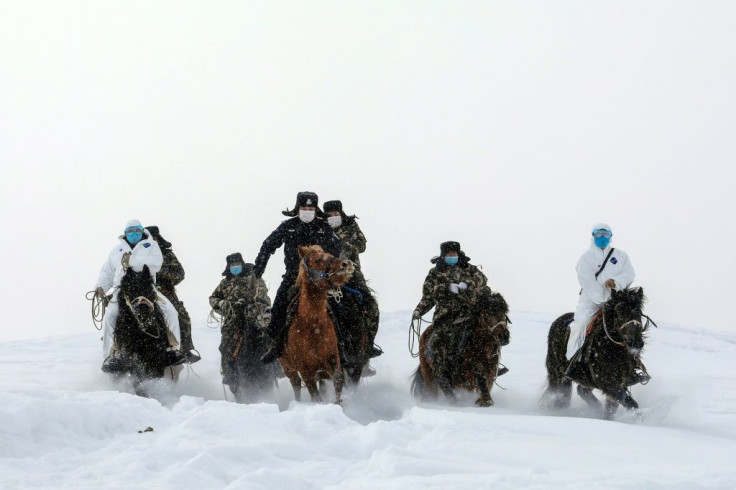 Mounted police visit residents who live in remote areas in Altay, farwest China's Xinjiang region, to promote awareness of the virus