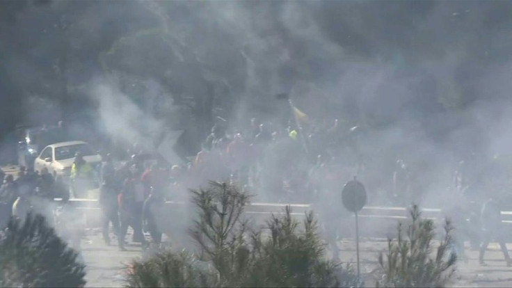 IMAGESProtesters throw stones at riot police near the town of Mantamados on the Greek island of Lesbos as they protest against the construction of a new migrant camp nearby.