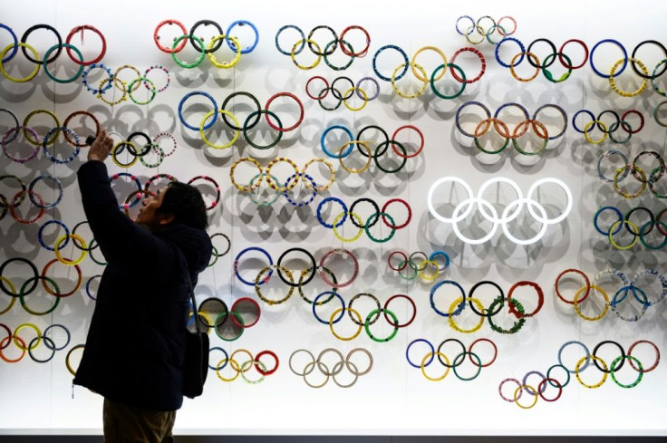 A man takes pictures at the Japan Olympic Museum in Tokyo. Organisers of the summer games insist they will go ahead despite the coronavirus outbreak