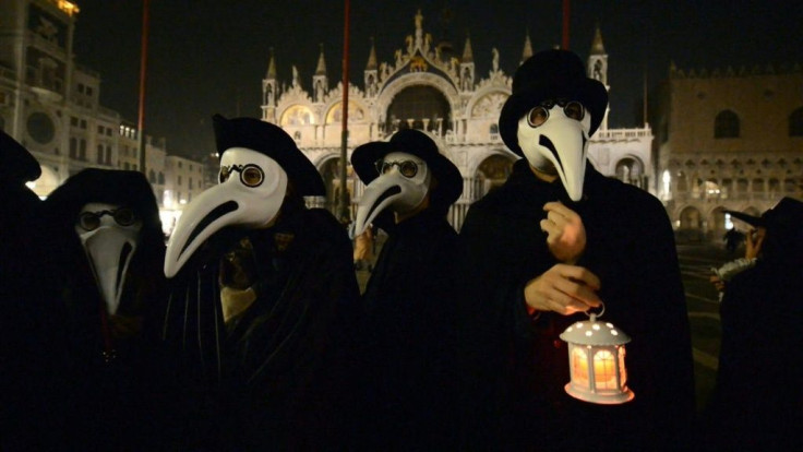 People take part in a traditional procession in San Barnaba Square on the last day of the Venice Carnival where many wear the type of masks used by doctors centuries ago to treat patients afflicted with the plague.