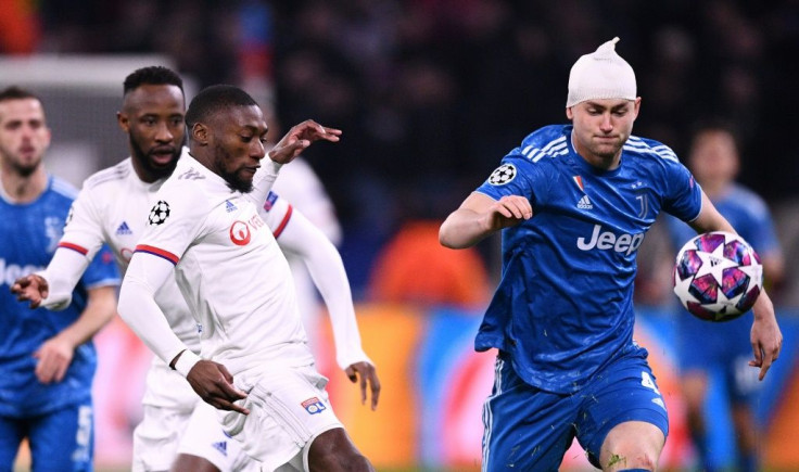 Matthijs de Ligt, his head heavily bandaged, takes on Karl Toko-Ekambi in the Champions League last-16 first leg between Lyon and Juventus