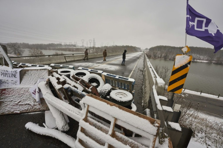 First Nations protestors walk on a bridge past their barricade on Highway 6 near Caledonia, Ontario which the protestors set up in support of the Wet'suwet'en hereditary chiefs and the Tyendinaga  Mohawks on February 26, 2020