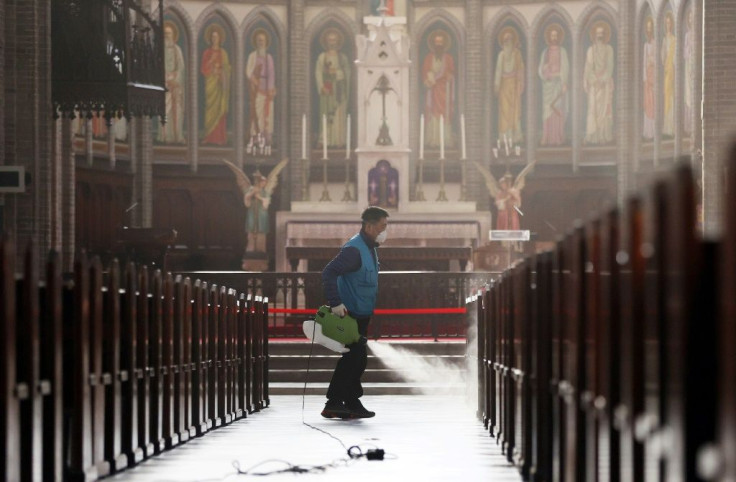 A staff member sprays disinfectant at Myeongdong Catholic Cathedral in Seoul