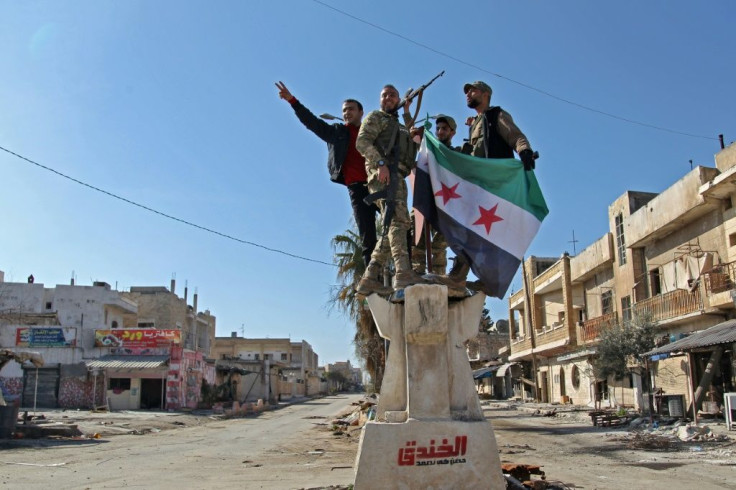 Turkish-backed Syrian rebels celebrate their recapture of the stategic crossroads town of Saraqib in a counterattack that reversed one of the main gains of a government offensive on their last major stronghold