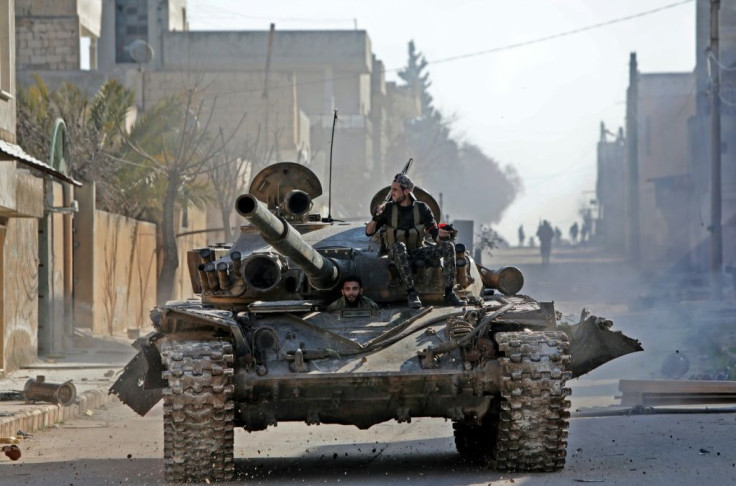 A rebel tank patrols the streets of Saraqeb, reduced to a ghost town abandoned by its residents after weeks of fighting