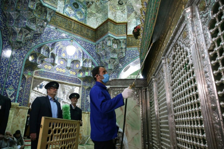 Iranian sanitary workers disinfect the Masumeh shrine in the Shiite holy city of Qom, where a prominent local member of parliament is among the latest people infected with the coronavirus