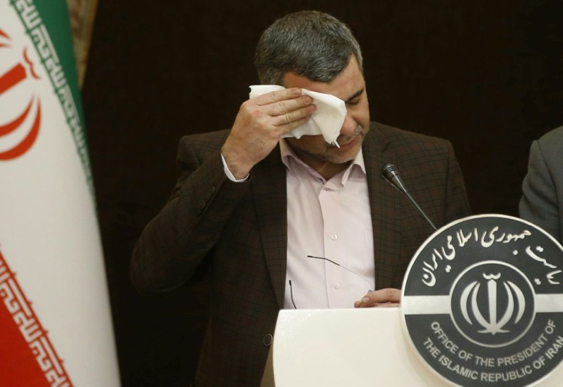 The head of Iran's coronavirus task force, Deputy Health Minister Iraj Harirchi, wipes sweat off his brow as he addresses a news conference hours before he is diagnosed as infected