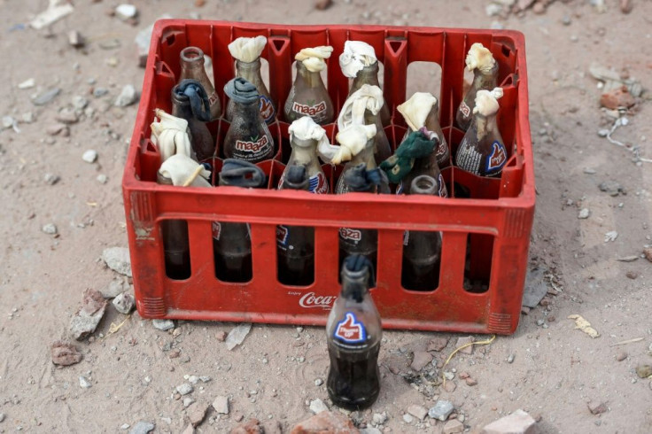 Masked men armed with crude petrol bombs burnt down shops during Delhi's sectarian riots