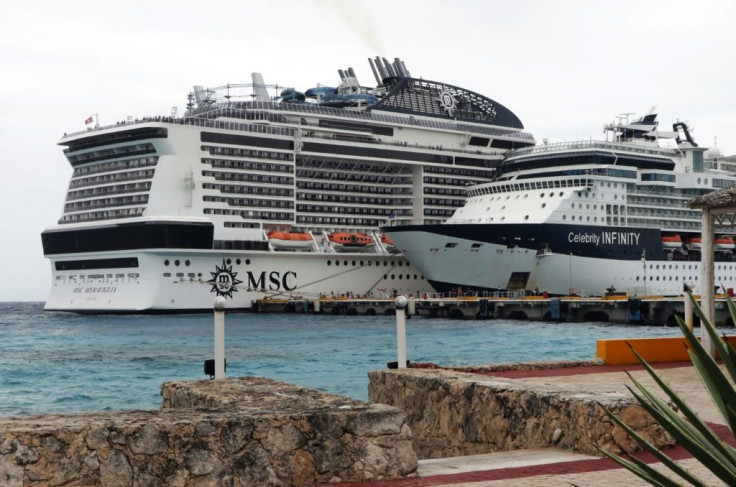 The MSC Meraviglia cruise ship (L) is seen in Cozumel, Mexico, after both Jamaica and the Cayman Islands refused to allow it to dock over fears of the new coronavirus