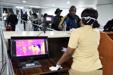A thermal scanner screens passengers at Lagos international airport