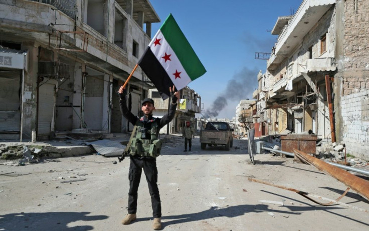 A Turkey-backed Syrian fighter celebrates in the Idlib province town of Saraqib, but the rebel counter offensive could be short-lived