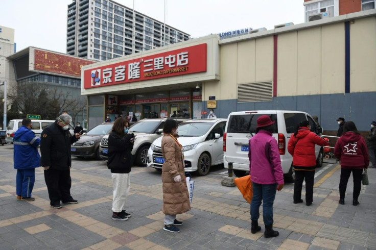 Beijing supermarkets now have restrictions on the number of shoppers inside, meaning some have to wait outside