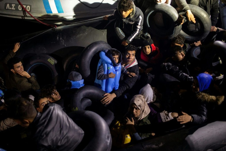 Migrants and refugees are seen on an inflatable boat during a rescue operation near the Greek island from Samos in November 2019
