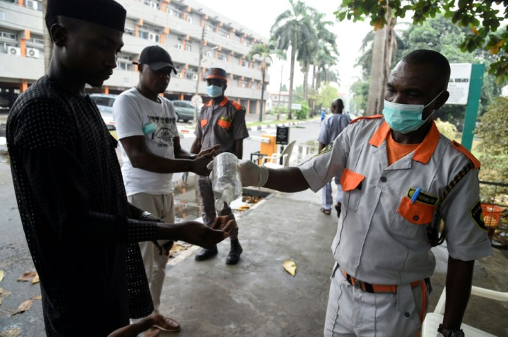 Hand hygiene: A visitor uses sanitisation gel before being allowed into a state hospital in Lagos