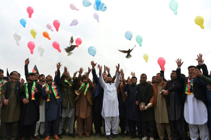 Afghans release balloons and pigeons in Jalalabad as they celebrate the reduction of violence in the country, ahead of a peace deal between the United States and the Taliban