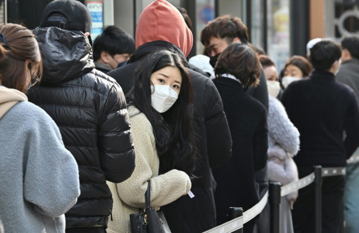 People wait in line to buy face masks at a store in Daegu, where more than 85 percent of South Korea's coronavirus cases have been detected