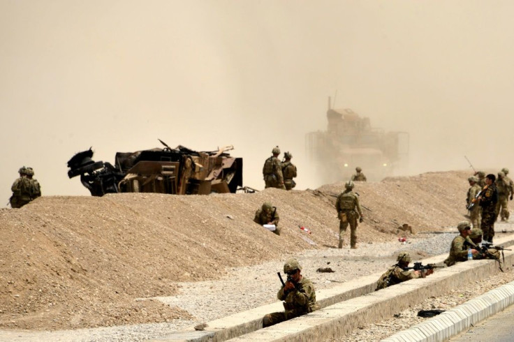 US soldiers and their wrecked vehicle after a Taliban suicide attack in Kandahar in August 2017