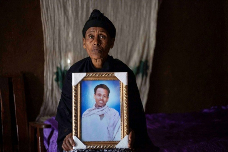 Mourning: Likitu Merdasa holds a portrait of her son, Desta Garuma