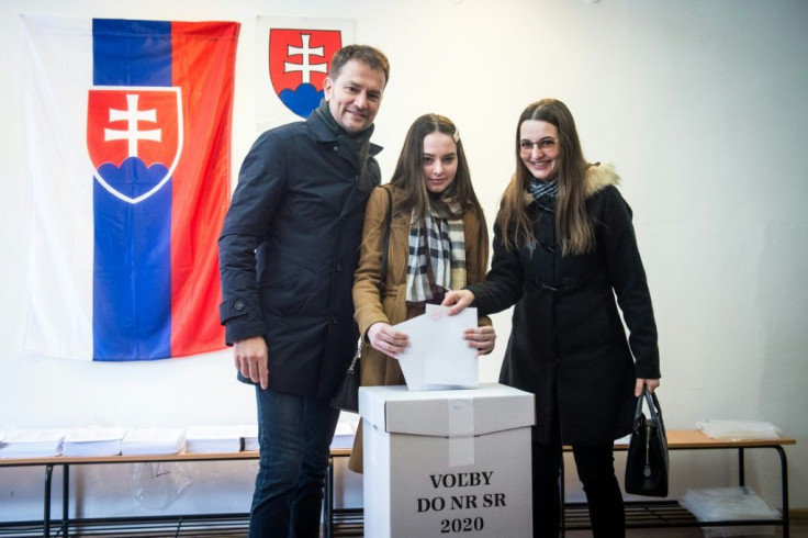 (L-R) Igor Matovic, leader of anti-graft political movement OLaNO, his daughter Rebeka and his wife Pavlina (R) vote in Slovakia's parliamentary election. The murder of a journalist who exposed high-level corruption has fueled desire for change.