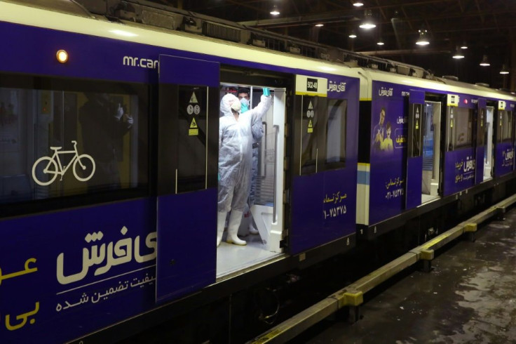 A municipal cleaner disinfects a metro train in Tehran as part of efforts to stem the spread of the coronavirus which has now killed 43 in Iran, according to official figures