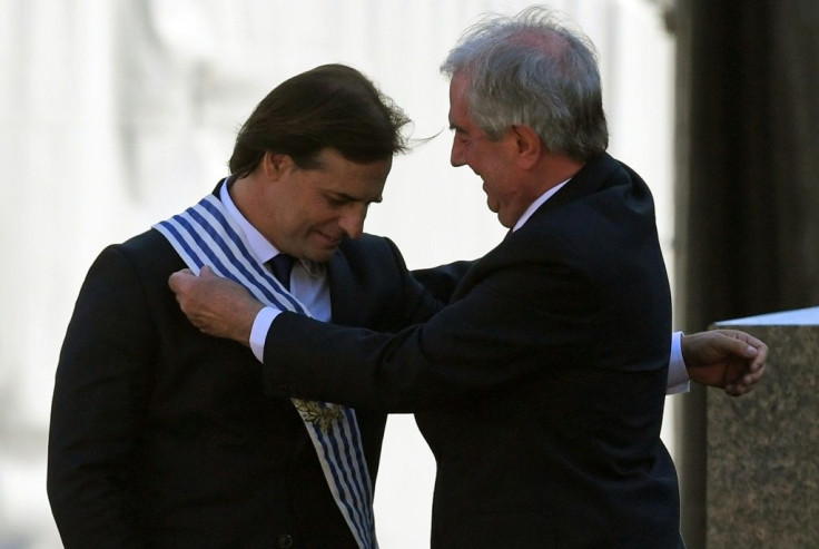 Uruguay's outgoing president Tabare Vazquez places the presidential sash on incoming leader Luis Lacalle Pou