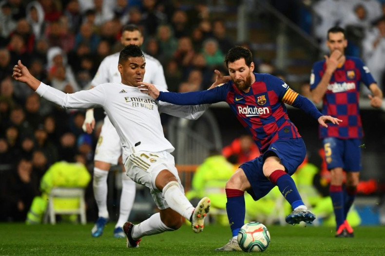 Real Madrid midfielder Casemiro challenges Barcelona's Lionel Messi