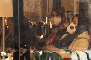 Iranian women wearing protective masks while riding a bus in the Iranian capital Tehran