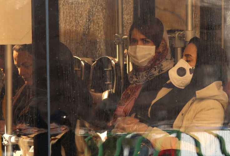 Iranian women wearing protective masks while riding a bus in the Iranian capital Tehran