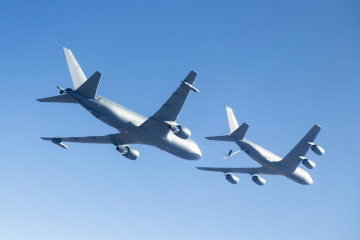 A Boeing KC-46A (L) conducts tests in 2015 over Edwards Air Force Base in California -- the tanker program has faced significant delays