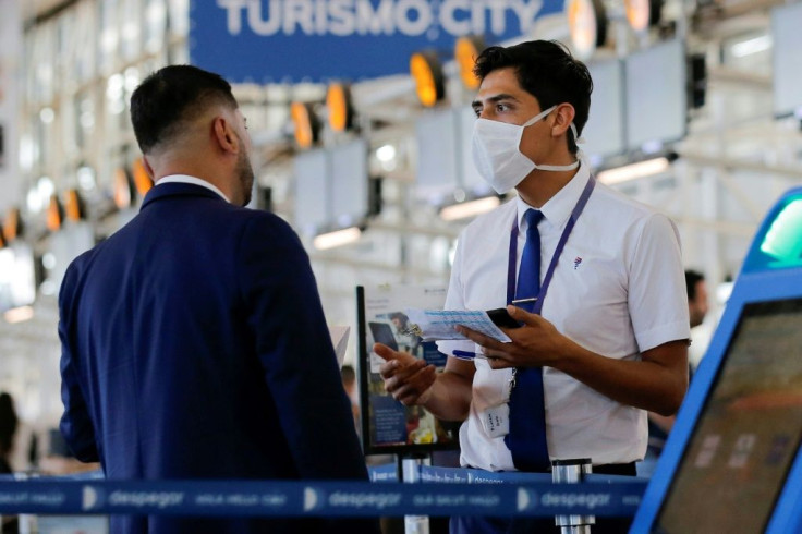 An airline staff member wears a mask while working at Arturo Merino Benitez International Airport in Santiago, Chile -- the new coronavirus has spread into Latin America and Africa