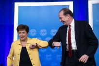 IMF Managing Director Kristalina Georgieva and World Bank Group President David Malpass bump elbows at the end of a joint press briefing on COVID-19 where they called for an all-out, coordinated global response