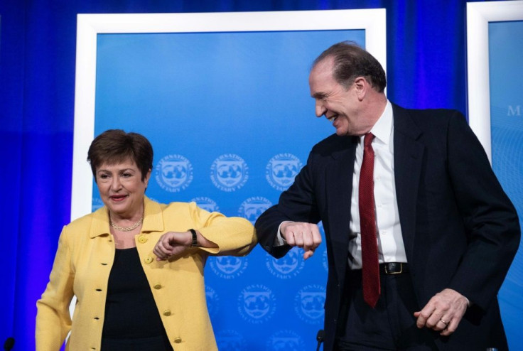 IMF Managing Director Kristalina Georgieva and World Bank Group President David Malpass bump elbows at the end of a joint press briefing on COVID-19 where they called for an all-out, coordinated global response