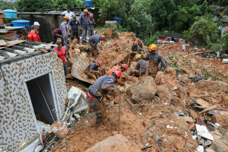 Rescuers search for victims at the Morro do Macaco Molhado favela in the coastal city of Guaruja, Sao Paulo, after it was struck by torrential rains