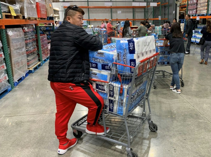 A man stocks up with 150 rolls of toilet paper at a store in Los Angeles