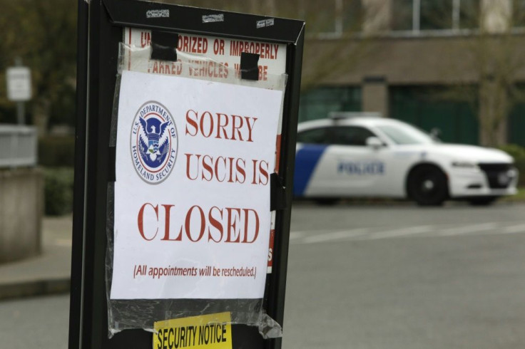 A closed sign is posted outside a Department of Homeland Security building and US Citizenship and Immigration Services field office after an employee was tested for the novel coronavirus in Tukwila, Washington