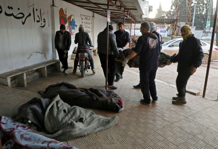 White Helmets rescuers carry bodied of civilians killed in reported Russian air strikes on northwestern Syria