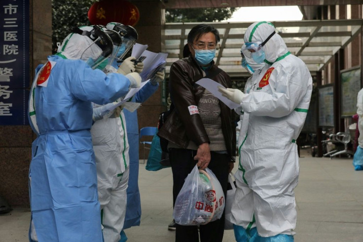 Medical staff check information as patients infected by the coronavirus transfer between hospitals in Wuhan