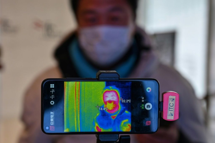 A man has his temperature measured at a mall in Shanghai