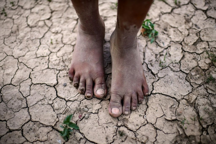 A girl stands on parched ground in the Wichi indigenous community of Mision Chaquena in Argentina's northern Salta province