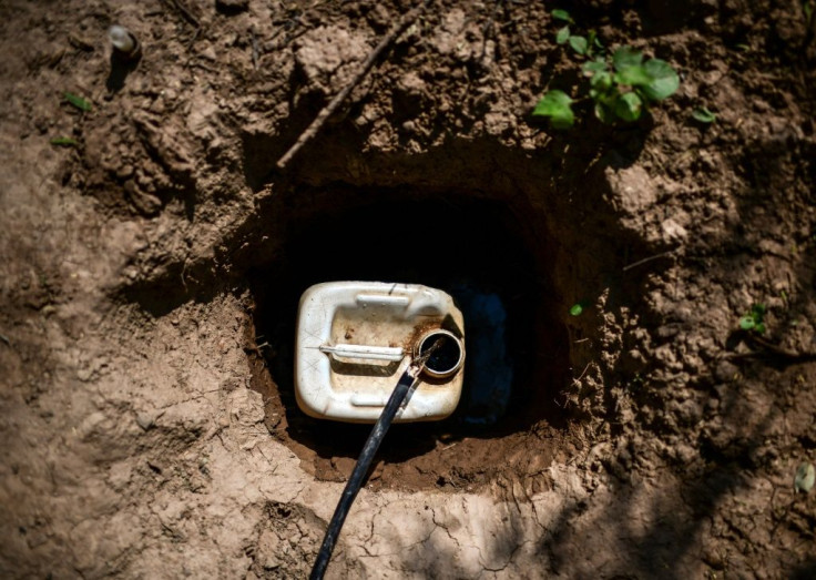 A container is being filled with water from a well in the Wichi indigenous community of Mision Chaquena, where children have been dying of hunger and diseases related to a lack of clean water