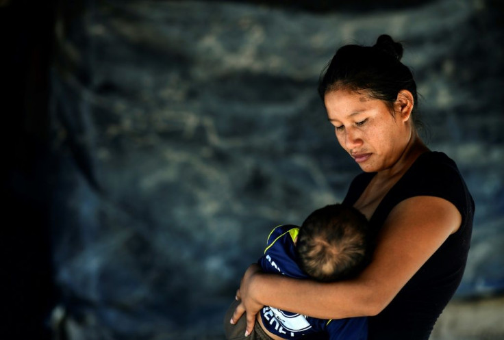 Indigenous Wichi woman Rosalia Gomez breastfeeds her son at their house in the indigenous community of Santa Victoria Este in Salta province