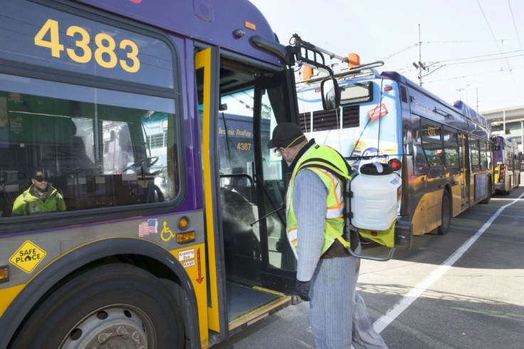 An equipment service worker for King County Metro sprays a disinfectant, throughout a metro bus in Seattle, Washington, a new focal point for the coronavirus epidemic