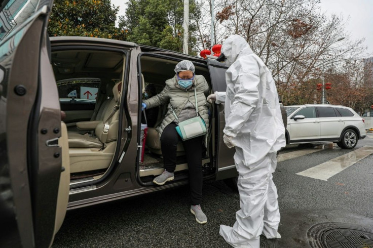 State media propaganda videos show volunteers in hazmat suits driving pregnant women to hospitals