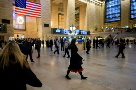 A woman walks through New York's Grand Central Station wearing a mask -- the state is one of at least 15 in the United States where cases of new coronavirus have been found